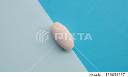Herbal medicine pill tablet on blue and white background Herbal medicine pill tablet on blue and white background 136854287