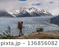 Hiker walking ridge overlooking vast Grey Glacier, Torres del Paine, Chile 136856082