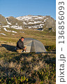 Male hiker cooking at wild camp in mountains above Hardangerfjord, Norway 136856093