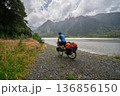 Male cyclist bikepacking on gravel trail near Haast River, New Zealand 136856150