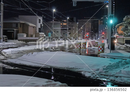 大雪で寒々とした夜に運行する富山路面電車 136856502