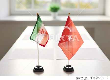 Iran and Turkey table flags prepared for diplomatic meeting in bright room 136856598