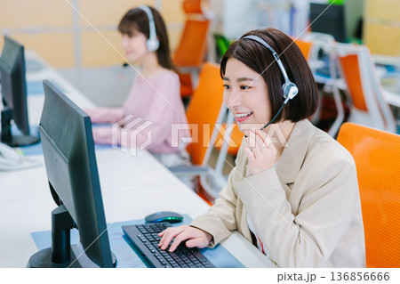 オフィスで電話を受ける女性オペレーター オフィスで電話を受ける女性オペレーター 136856666