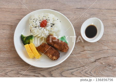 crispy fried pork tonkatsu with sweet fried egg on black sesame rice topping tomato Japanese bento set on plate crispy fried pork tonkatsu with sweet fried egg on black sesame rice topping tomato Japanese bento set on plate 136856756