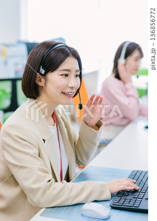 オフィスで電話を受ける女性オペレーター オフィスで電話を受ける女性オペレーター 136856772