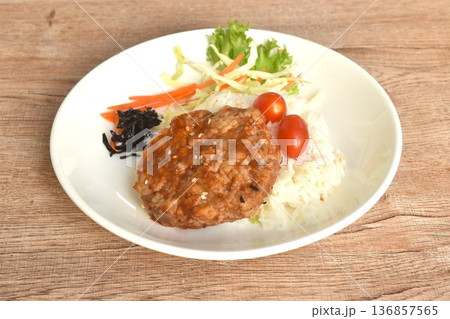 fried pork hamburg steak topping plain rice with salad and dry seaweed on plate 136857565