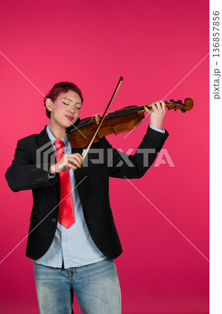 Individual playing violin with passion and focus 136857856