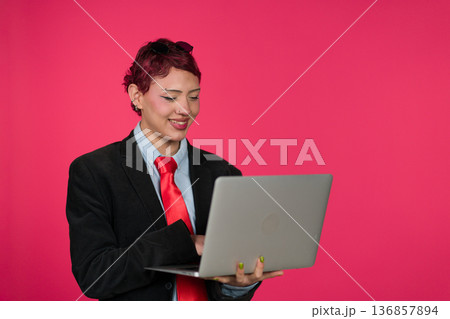 Young identifying person smiling working on laptop 136857894