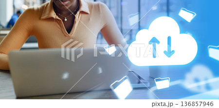 Person using laptop for cloud storage and file transfer in a modern workspace setting 136857946