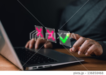 person interacts with a laptop selecting a glowing green checkmark among red X symbols representing decision making,approval processes,rejection choices,verification,and digital confirmation workflow. person interacts with a laptop selecting a glowing green checkmark among red X symbols representing decision making,approval processes,rejection choices,verification,and digital confirmation workflow. 136858468