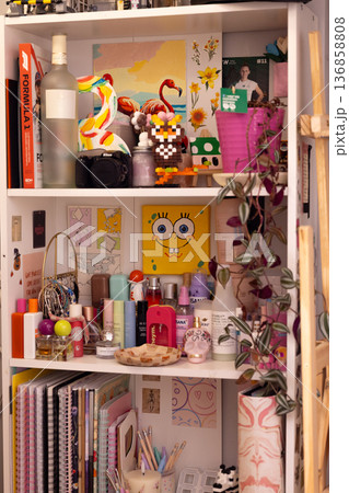 Colorful shelf filled with various items and decorations in a cozy room Colorful shelf filled with various items and decorations in a cozy room 136858808