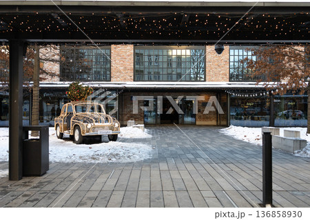 Car decorated for holidays stands outside a modern building in winter Car decorated for holidays stands outside a modern building in winter 136858930