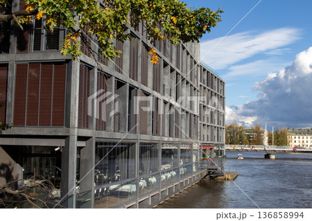 Modern riverside building reflects contemporary architecture in a lively city Modern riverside building reflects contemporary architecture in a lively city 136858994