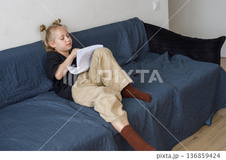 Adorable little child girl reading book at home, indoor portrait Adorable little child girl reading book at home, indoor portrait 136859424