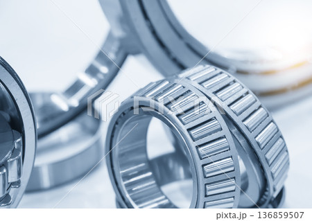 Group of high-precision tapered roller bearings designed for combined radial and axial load distribution in industrial applications. Group of high-precision tapered roller bearings designed for combined radial and axial load distribution in industrial applications. 136859507