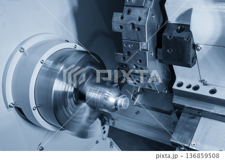Precision CNC lathe machine performing high-speed cutting on a high-grade metal mold component for plastic bottle production. 136859508