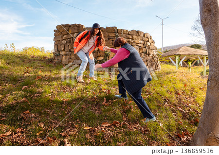 Elderly Caucasian grandmother spends a sunny afternoon with her granddaughter in a city park. Leisure, happiness, and family connection in retirement. Elderly Caucasian grandmother spends a sunny afternoon with her granddaughter in a city park. Leisure, happiness, and family connection in retirement. 136859516