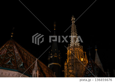 Fisherman's Bastion in Budapest illuminated at night. The historic structure features turrets and arches, surrounded by a quiet plaza. 136859876