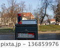 Can of drink placed on top of parking meter in a city during daytime 136859976
