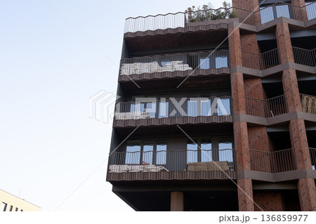 Building features balconies and windows in a city during daylight hours 136859977