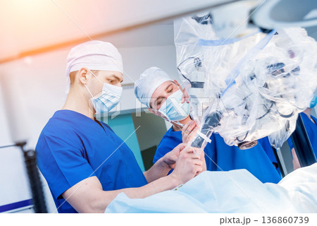 Spinal surgery. Group of surgeons in operating room with surgery equipment.  136860739