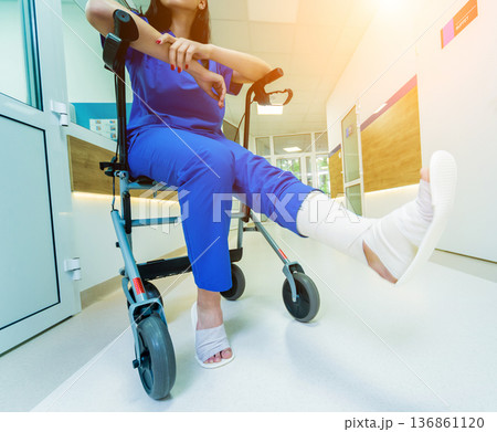 Patient on rollator with hand brakes moving in hospital 136861120