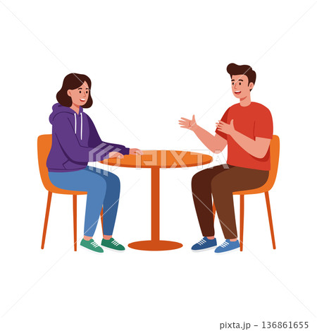 Two people having a friendly conversation sitting at a round table indoors casual clothing lifestyle scene Two people having a friendly conversation sitting at a round table indoors casual clothing lifestyle scene 136861655