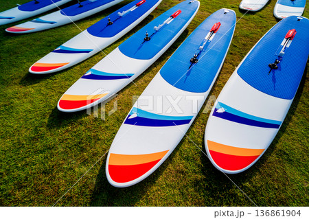 A lot of surfboards on the beach. Summer background. A lot of surfboards on the beach. Summer background. 136861904