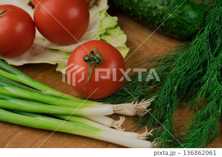 Fresh vegetables on a chopping wooden board, about to turn into a salad. Fresh vegetables on a chopping wooden board, about to turn into a salad. 136862061