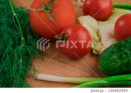 Fresh vegetables for salad on a cutting wooden board Fresh vegetables for salad on a cutting wooden board 136862084