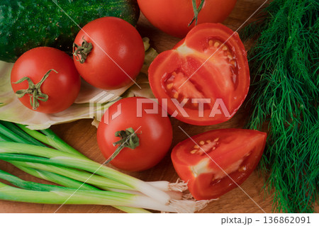 Spring vitamin set of various green leafy vegetables on a wooden board. 136862091