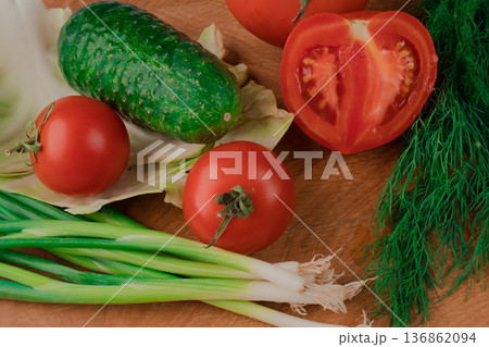 Spring vitamin set of various green leafy vegetables on a wooden board. Spring vitamin set of various green leafy vegetables on a wooden board. 136862094