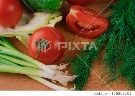 Spring vitamin set of various green leafy vegetables on a wooden board. Spring vitamin set of various green leafy vegetables on a wooden board. 136862102