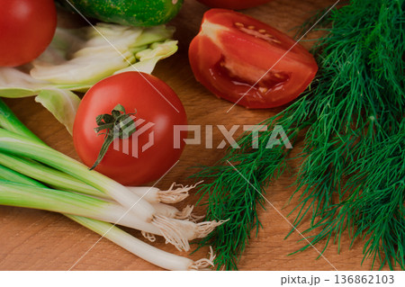 Spring vitamin set of various green leafy vegetables on a wooden board. Spring vitamin set of various green leafy vegetables on a wooden board. 136862103