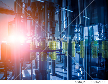 Bottling line of sunflower oil in bottles. Vegetable oil production plant. 136862136