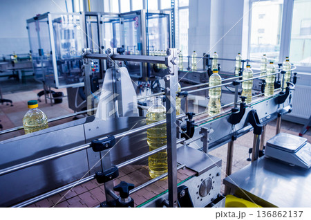 Bottling line of sunflower oil in bottles. Vegetable oil production plant. Bottling line of sunflower oil in bottles. Vegetable oil production plant. 136862137