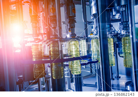 Bottling line of sunflower oil in bottles. Vegetable oil production plant. Bottling line of sunflower oil in bottles. Vegetable oil production plant. 136862143