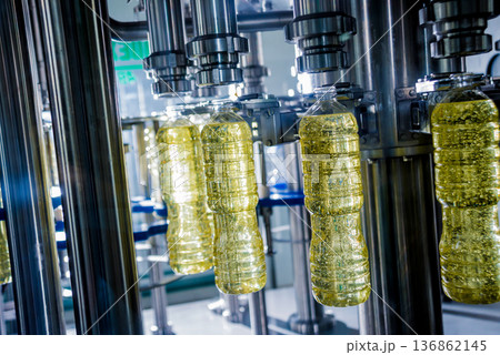 Bottling line of sunflower oil in bottles. Vegetable oil production plant. Bottling line of sunflower oil in bottles. Vegetable oil production plant. 136862145