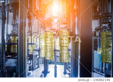 Bottling line of sunflower oil in bottles. Vegetable oil production plant. 136862146