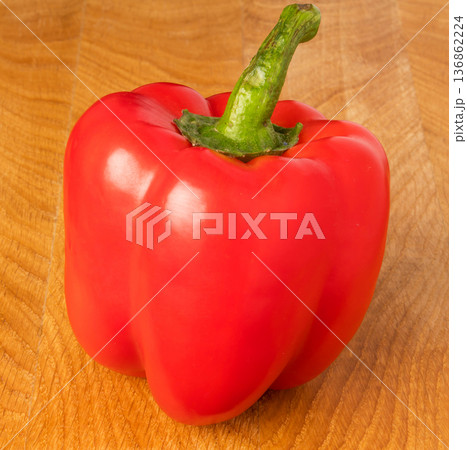 red sweet pepper on a wooden board red sweet pepper on a wooden board 136862224