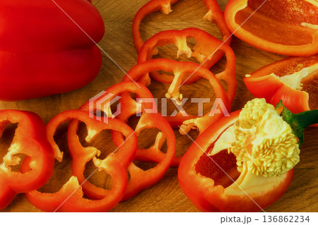 Sweet pepper whole and slices on a wooden board Sweet pepper whole and slices on a wooden board 136862234
