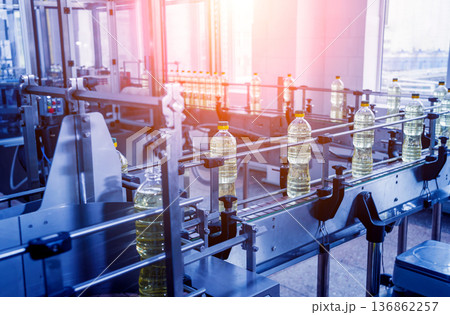 Bottling line of sunflower oil in bottles. Vegetable oil production plant. Bottling line of sunflower oil in bottles. Vegetable oil production plant. 136862257