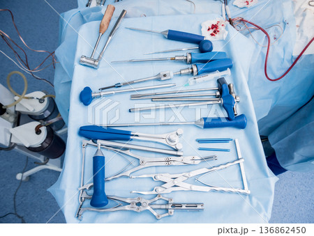 Sterilized surgical instruments and tools on the blue table. Sterilized surgical instruments and tools on the blue table. 136862450