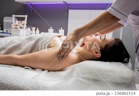 Beautiful young woman enjoying massage in spa salon. Cosmetology Beautiful young woman enjoying massage in spa salon. Cosmetology 136862514
