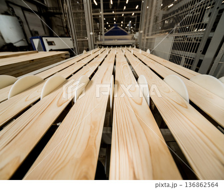 Production line of the wooden floor factory. CNC automatic woodworking machine. 136862564