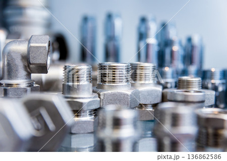 Hosepipe fittings on the table. Plumbing pipeline spare parts. 136862586