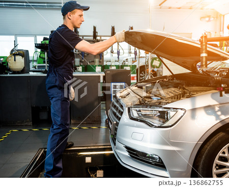 Car mechanic repair engine at service station. Car repair 136862755