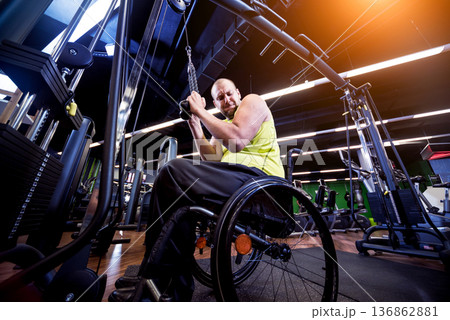 Disabled man training in the gym of rehabilitation center Disabled man training in the gym of rehabilitation center 136862881