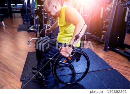 Disabled man training in the gym of rehabilitation center Disabled man training in the gym of rehabilitation center 136862891