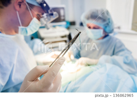 Spinal surgery. Group of surgeons in operating room with surgery equipment.  136862965